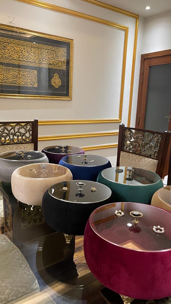 Colorful round Turkish Hotpots in a room with decorative wall art